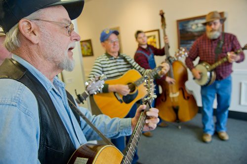 Gene Terry (left), Tommy Nations, Ben Malloy and Allen Malloy perform inside the Center Town Gallery on Main Street during the Stone Mountain Village Blue Grassroots Music and Arts Festival on Saturday, March 23, 2013. 