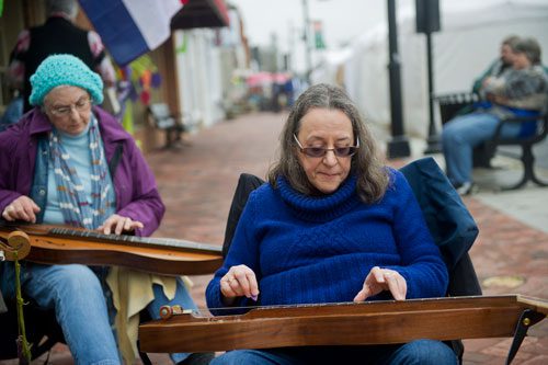 Pam Deemer (right) and Carol Downs perform on Main Street during the Stone Mountain Village Blue Grassroots Music and Arts Festival on Saturday, March 23, 2013.