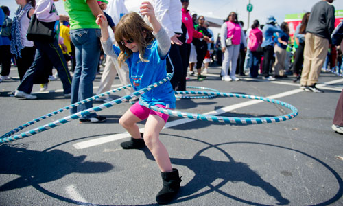 Carlie Boxt hulahoops before the start of the Hunger Walk/Run 2013 through downtown Atlanta on Sunday, March 10, 2013.