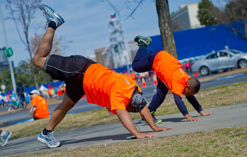 A father and son stretch before the Hunger Walk/Run 2013 through downtown Atlanta on Sunday, March 10, 2013.
