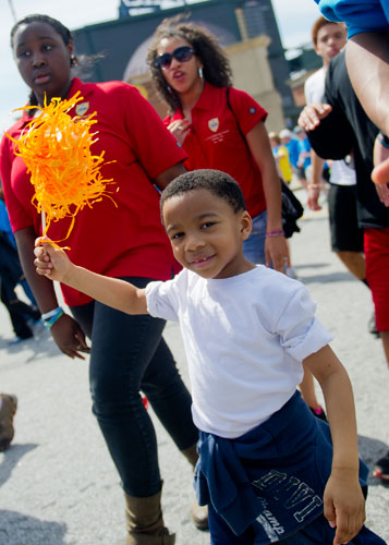 Christian Bodrick holds up a streamer as he walks in the Hunger Walk/Run 2013 through downtown Atlanta on Sunday, March 10, 2013.