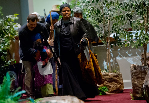 Darlene Kerr (center) plays Harriet Tubman during a scene from "And Still We Sing...The African-American Spiritual Journey as Nurtured by Song" at Zion Missionary Baptist Church in Roswell on Friday, February 22, 2013. 