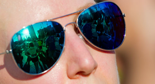 Centennial Olympic Park is reflected in a runner's glasses as she crosses the finish line during the 2013 Publix Georgia Marathon/Half Marathon in Atlanta on Sunday, March 17, 2013.