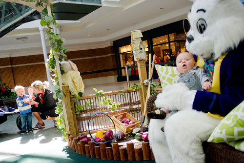 Liam Whitmer (left) sizes up the Easter Bunny as his mother Leigh tries to convince him to join his brother Colton for a visit at North Point Mall in Alpharetta on Thursday, March 21, 2013. 