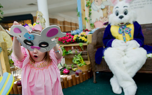 Kylie Cornett (left) tries on a bunny mask after her visit with the Easter Bunny at North Point Mall in Alpharetta on Thursday, March 21, 2013.