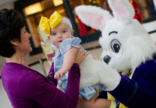 Keitha Gardiner (left) lifts her granddaughter Avery Claire Lanham out of the arms of the Easter Bunny after a visit at North Point Mall in Alpharetta on Thursday, March 21, 2013. 
