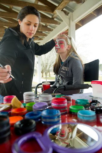 Corinne Smith (left) paints Dallas Dunn's face before the start of the Easter Egg Hunt at Nash Farm Battlefield in Hampton on Friday, March 22, 2013.
