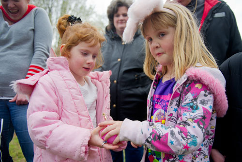 Ansley Turpin (left) passes a plastic egg to Jaley Morris during a game of hot potato during the Easter Egg Hunt at Nash Farm Battlefield in Hampton on Friday, March 22, 2013.