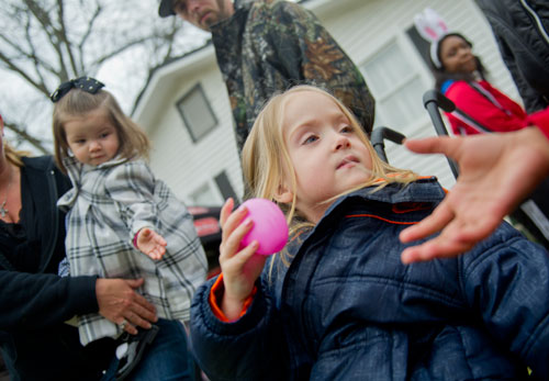 Kayleah Holliman passes a plastic egg during a game of hot potato during the Easter Egg Hunt at Nash Farm Battlefield in Hampton on Friday, March 22, 2013.