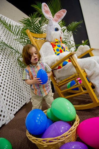 Oscar Leon (left) grasps one of the Easter Bunny's giant eggs during the fifth annual Easter Egg Hunt at Hebron Christian Church in Winder on Sunday, March 24, 2013. 