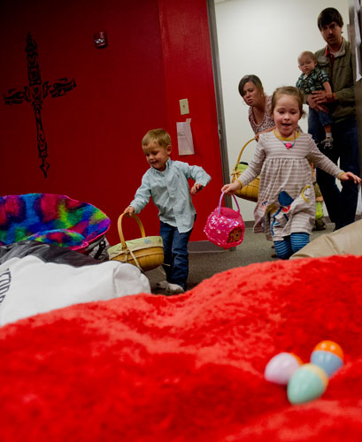 Leslie Bradley and John Elder rush into a room searching for eggs during the fifth annual Easter Egg Hunt at Hebron Christian Church in Winder on Sunday, March 24, 2013.