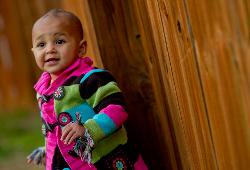 Theadora Mabika explores outside at her grandparent's house in Norcross on Thursday, March 7, 2013.