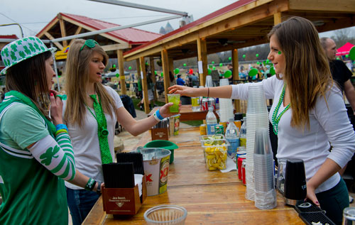 Bryanne Salmonsen (left) and her sister Kirsten buy drinks from bartender Rachel Zick during LuckyFest 2013 at Park Tavern in Atlanta on Saturday, March 9, 2013. 