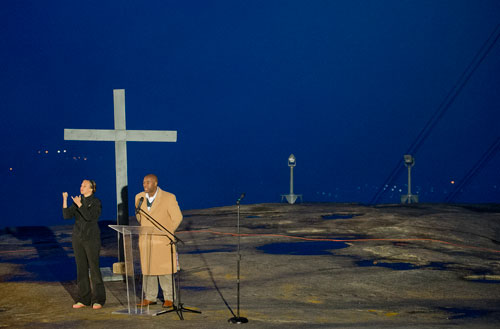 Bill Green (right) of New Covenant Christian Ministries reads the call to worship and prayer as an interpreter signs during the 69th annual Easter Sunrise Service on top of Stone Mountain at Stone Mountain Park on Sunday, March 31, 2013