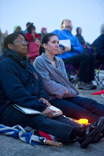 Lisa D. Lewis (left) holds her bible as she sits next to Beverly Jackson during the 69th annual Easter Sunrise Service on top of Stone Mountain at Stone Mountain Park on Sunday, March 31, 2013.