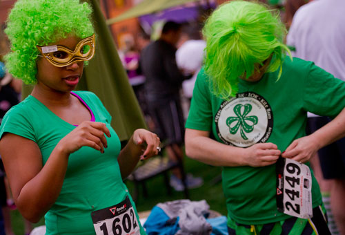 Renee Abrams (left) and Lindsay Murphy prepare for the Junior League of Atlanta's 9th annual ShamRock 'N Roll Road Race on Sunday, March 10, 2013. 