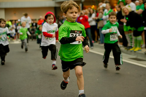 Ethan Robinson (center) runs in the Leprechaun Dash for Gold Tot Trot during the Junior League of Atlanta's 9th annual ShamRock 'N Roll Road Race on Sunday, March 10, 2013. 