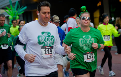  Suzi Burnette (152) and Jeff Burnette (149) run in the 5k during the Junior League of Atlanta's 9th annual ShamRock 'N Roll Road Race on Sunday, March 10, 2013. 