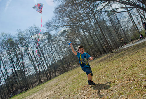 Troy Marquez runs through Jones Bridge Park in Peachtree Corners as he launches his kite into the air on Saturday, March 30, 2013. 