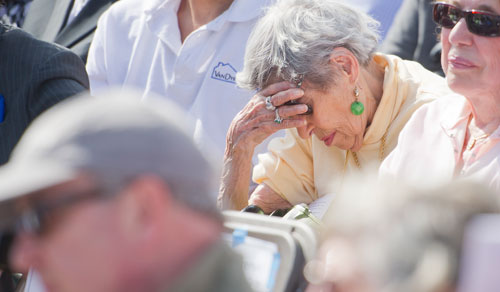 Ursula Draker (center) closes her eyes and places her head in her hand as a poem is read during the Yom HaShoah commemoration ceremony at the Marcus Jewish Community Center of Atlanta in Dunwoody on Sunday, April 7, 2013.