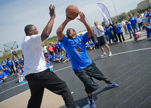 Antonio Jackson (right) goes head to head against Dominique Wilkins during the Allstate NABC Good Works Team Basketball Clinic at Atlantic Station in Atlanta on Sunday, April 7, 2013. 