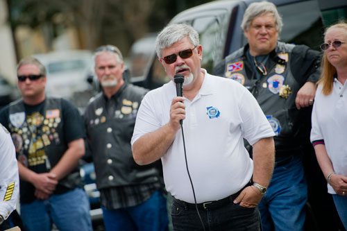 Ed Christian, president of Chapter 7 of the Blue Knights Law Enforcement Motorcycle Club, speaks during the unveiling of three officers' names on the Georgia Law Enforcement Memorial Wall outside of the Public Safety Headquarters in Atlanta on Thursday, April 11, 2013. 