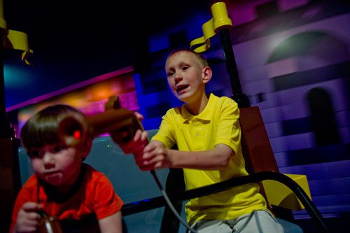 Lance WItt (right) and his cousin Cooper Neubauer point their laser guns as they battle trolls inside the LEGOLAND Discovery Center at Phipps Plaza in Buckhead on Monday, April 8, 2013.