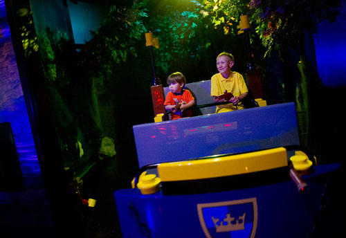 Lance WItt (right) and his cousin Cooper Neubauer point their laser guns as they battle trolls inside the LEGOLAND Discovery Center at Phipps Plaza in Buckhead on Monday, April 8, 2013.
