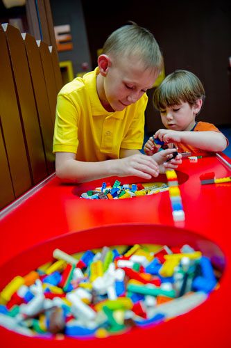 Lance Witt (left) and his cousin Cooper Neubauer build with LEGOs at the LEGOLAND Discovery Center at Phipps Plaza in Buckhead on Monday, April 8, 2013.
