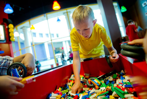 Lance Witt (center) digs in a bucket of LEGOs for the perfect piece as he builds a racecar at the LEGOLAND Discovery Center at Phipps Plaza in Buckhead on Monday, April 8, 2013.