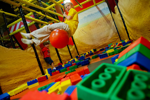 Lance Witt (center) rides the wrecking ball as his cousin Cooper Neubauer watches at the LEGOLAND Discovery Center at Phipps Plaza in Buckhead on Monday, April 8, 2013. 