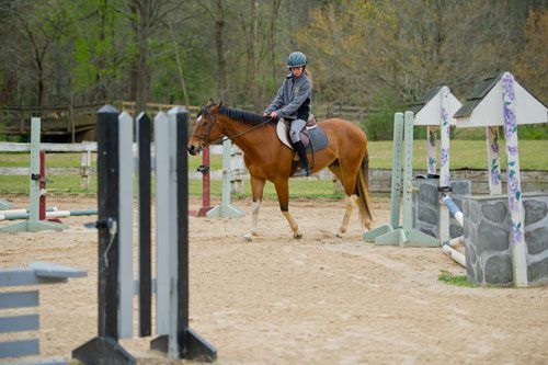 Eva Kretsinger-Walters leads her horse around the training ring at Little Creek Horse Farm in Decatur on Wednesday, April 3, 2013.