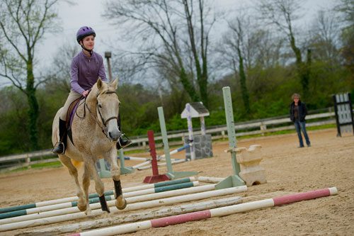 Julia Fleischer (left) rides her horse around the training ring as she takes a lesson with Dana McDaniel of Atlanta In-Town Riding Academy at Little Creek Horse Farm in Decatur on Wednesday, April 3, 2013. 