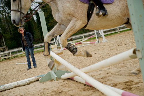 Instructor Dana McDaniel (left) watches as Julia Fleischer leads her horse over a jump in the training ring during a lesson with Atlanta In-Town Riding Academy at Little Creek Horse Farm in Decatur on Wednesday, April 3, 2013. 