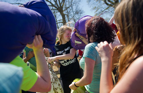 Emily Phillips (center) tries to defend herself amidst the fray during the pillow fight at Freedom Park in Little Five Points on Saturday, April 6, 2013.