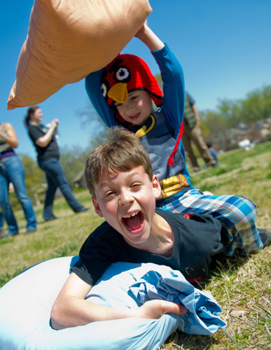 Daniel Orta (bottom) is pummelled with a pillow by Liam Gallagher during the pillow fight at Freedom Park in Little Five Points on Saturday, April 6, 2013.