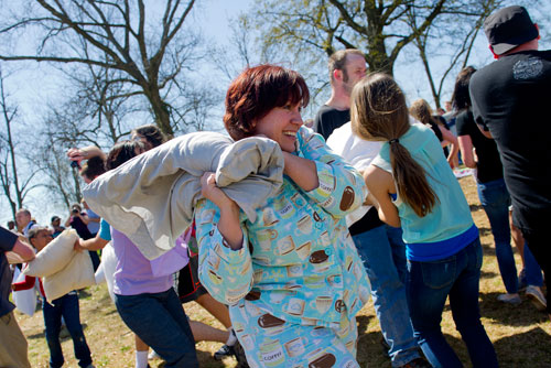 Kim Helms (center) battles new friends during the pillow fight at Freedom Park in Little Five Points on Saturday, April 6, 2013.