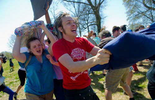 Buddy Smith (center) and Catie Leary charge into the fray with pillows raised during the pillow fight at Freedom Park in Little Five Points on Saturday, April 6, 2013. 