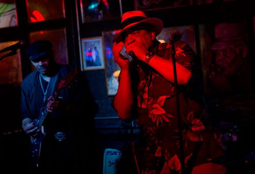 Brother Dave Chandler (right) plays the harmonica as he performs on stage during a tribute for the late Robert "Chicago Bob" Nelson at the Northside Tavern in Atlanta on Saturday, April 6, 2013.