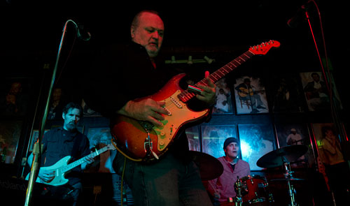 Tinsley Ellis (center) performs with Jim Ransome (left) and Trevor Roberts of the Breeze Kings on stage at the Northside Tavern in Atlanta on Saturday, April 6, 2013. 