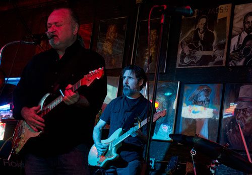 Tinsley Ellis (left) plays the guitar as he performs with Jim Ransome, guitarist for the Breeze Kings, on stage at the Northside Tavern in Atlanta on Saturday, April 6, 2013. 