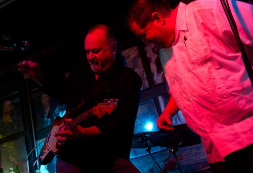 Tinsley Ellis (left) plays the guitar as he performs with Carlos Capote, lead singer of the Breeze Kings, on stage at the Northside Tavern in Atlanta on Saturday, April 6, 2013. 