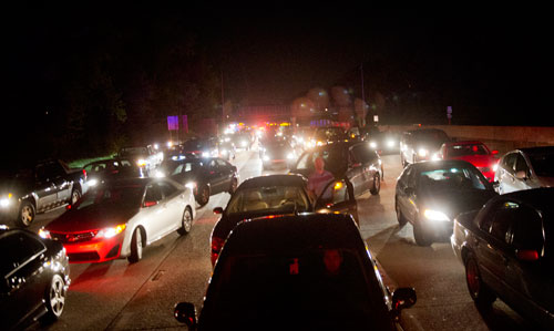 Traffic sits at a standstill on 400 southbound in Sandy Springs just north of the Northridge exit after police shot and killed a suspect who shot an Alpharetta police officer three times earlier in the evening on Friday, April 12, 2013.