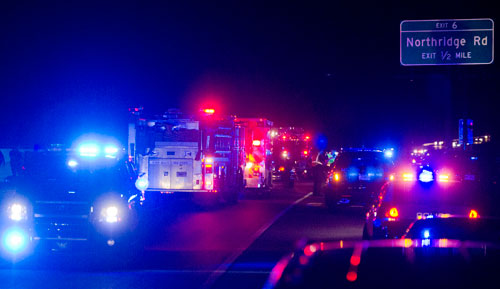 Police and emergency personnel work the scene on Northridge Rd on 400 southbound in Sandy Spring after a officer shooting suspect opened fire on other officers at the end of a high speed chase on Friday, April 12, 2013.