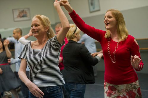 All About Ballroom instructor Kathy Casper (right) spins Joan Sanborn as she teaches a salsa class in Alpharetta on Saturday, April 13, 2013. 