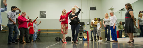 All About Ballroom instructor Kathy Casper (left center) spins Samantha Ryan as she teaches a salsa class in Alpharetta on Saturday, April 13, 2013.