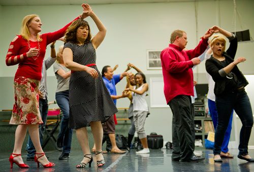 All About Ballroom instructor Kathy Casper (left) spins Chieko Saito as David Robinson spins Samantha Ryan (right) during a salsa class in Alpharetta on Saturday, April 13, 2013.