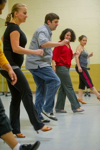 Mirka Roach (left), Marie Collantes (right) and Marise Teixeira follow Dance 4 Fun instructor Matthew Johnson (center) as he teaches them a new dance step during a swing class in Lawrenceville on Monday, April 15, 2013. 