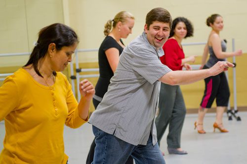 Dance 4 Fun instructor Matthew Johnson (center) looks over to Suji Rao as she follows along learning a new dance step during a swing class in Lawrenceville on Monday, April 15, 2013. 