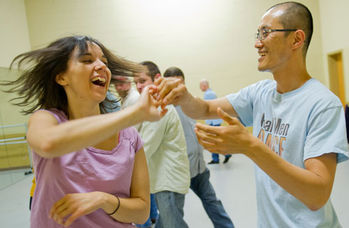 Kim Dyckman (left) is spun by Taeook Kwon as they practice a new dance step during a Dance 4 Fun swing class in Lawrenceville on Monday, April 15, 2013. 